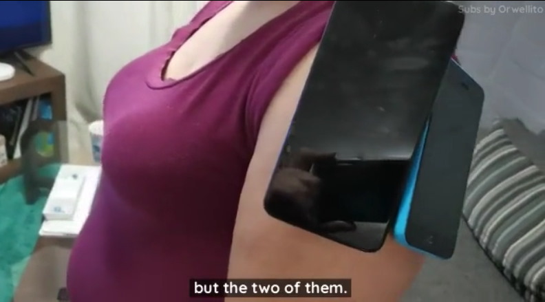 ORWELL-CITY-MagnetGate-Two-cell-phones-get-sticked-to-her-arm